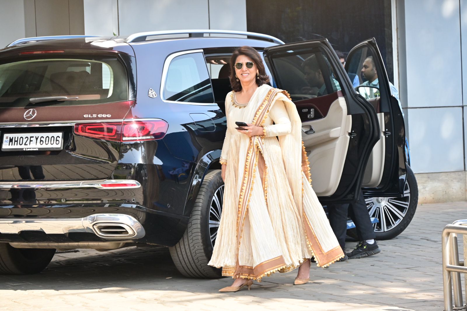 Neetu Kapoor wore a plain off-white outfit featuring golden embroidery. She was all smiles as she greeted the paparazzi