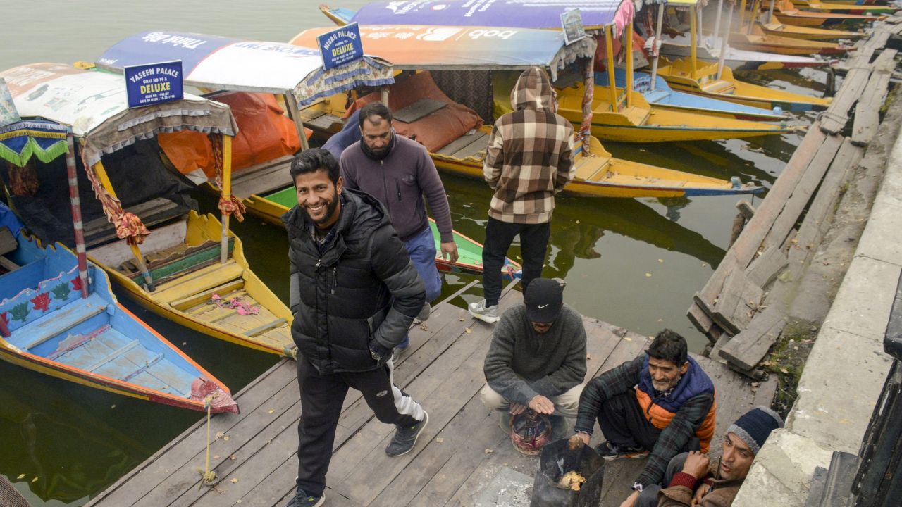 As winter envelops Srinagar, the fog hangs heavy over the city, cloaking the ancient Mughal gardens, the bustling markets, and the charming old streets. (In Pic: Shikara owners warm themselves around a bonfire at the Dal Lake on a foggy winter afternoon, in Srinagar on Saturday)