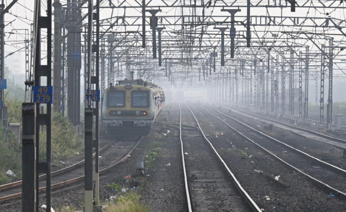 Local trains pass through fog at Thakurli railway station in Dombivli