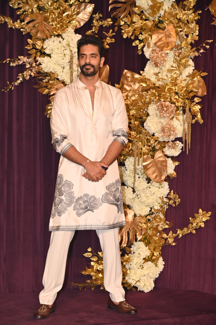 Angad Bedi looked handsome in a white kurta with a stylish floral print, paired with matching payjamas