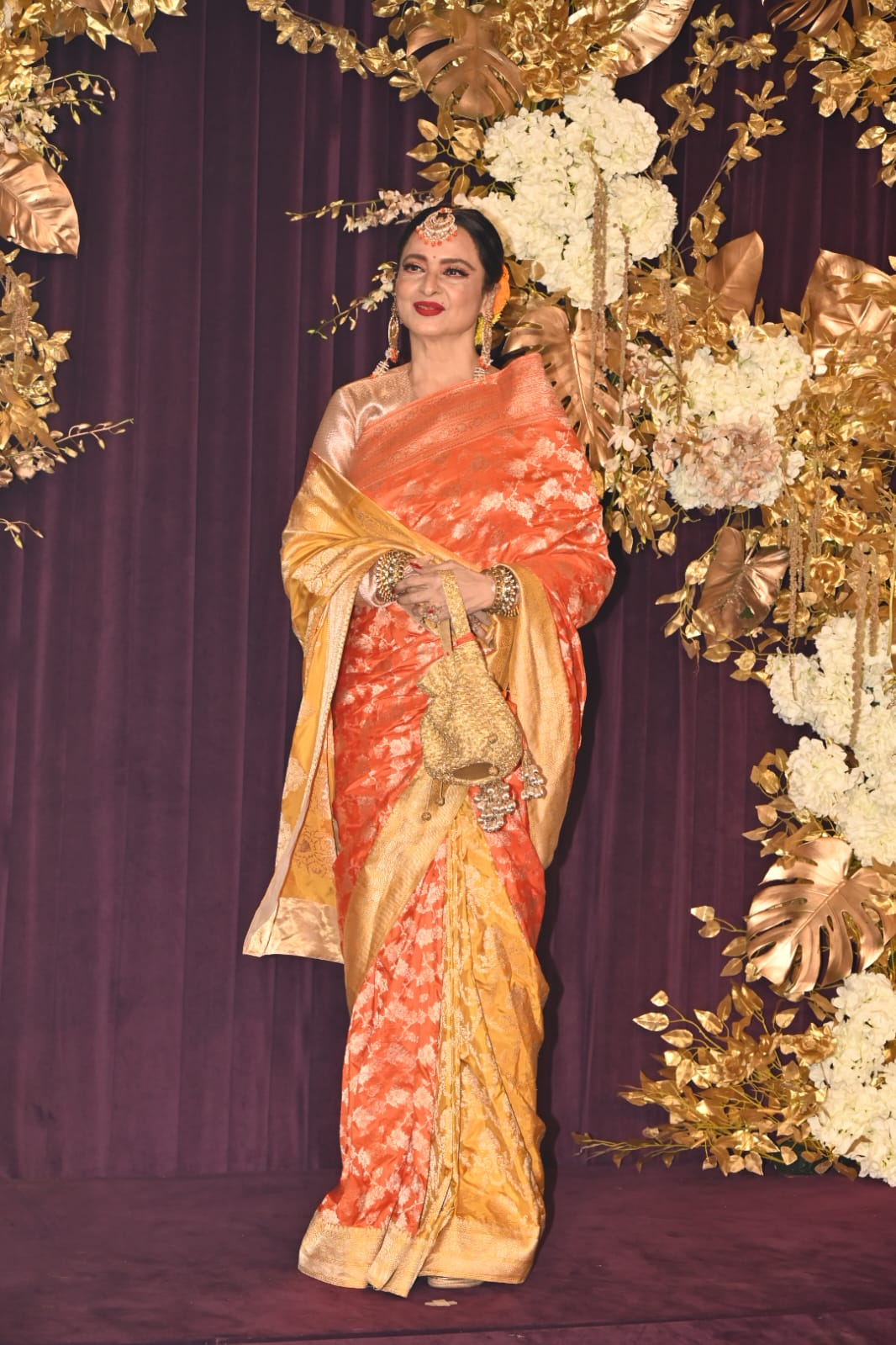 The iconic Rekha ji stole our hearts in a beautiful orange and yellow saree. The actress wore stunning heavy jewellery and tied her hair in a chic bun